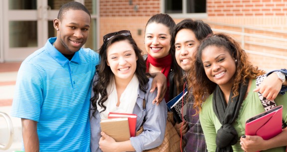 Education: Multi-ethnic group of college friends hang out before class.