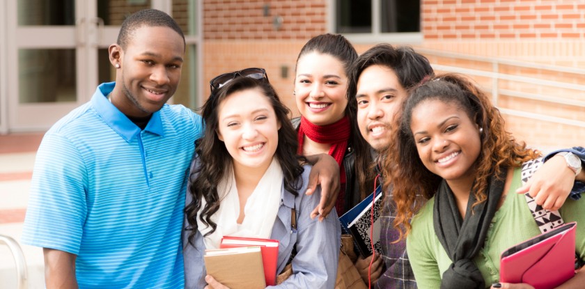 Education: Multi-ethnic group of college friends hang out before class.